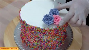 Applying roses to cake
