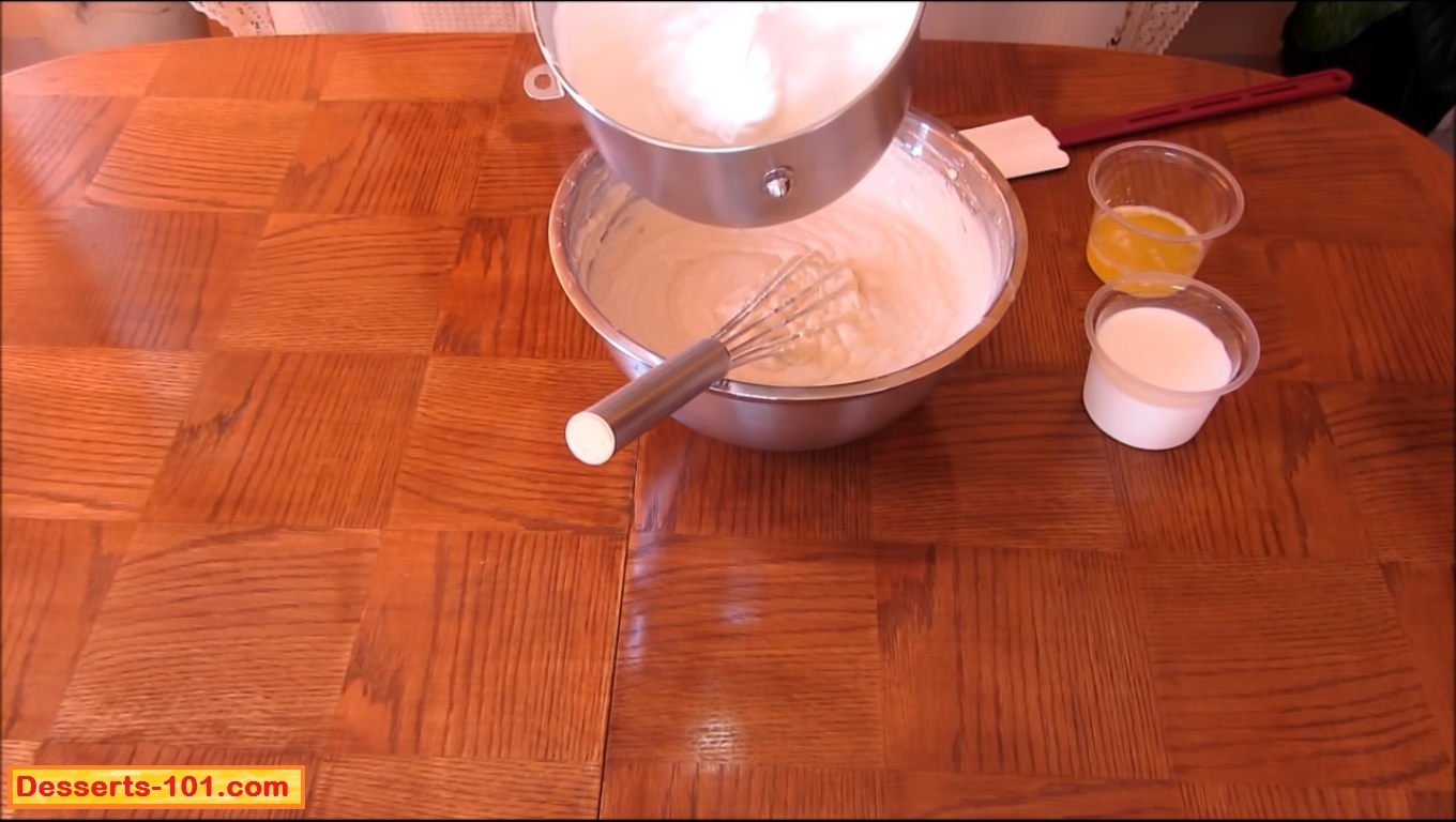 Continue whipping the egg white mixture until soft peaks form