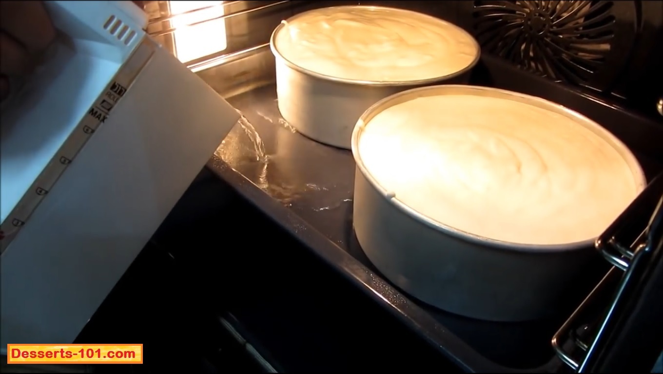 Add hot/boiling water to create a water bath to bake the cheesecakes in.