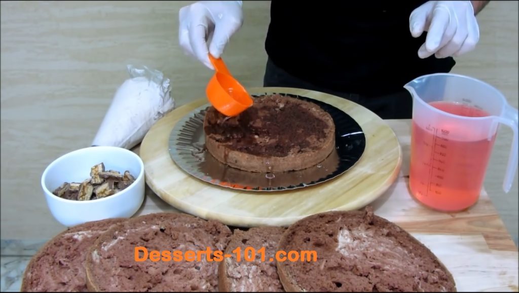 Moistening the cake with simple syrup.